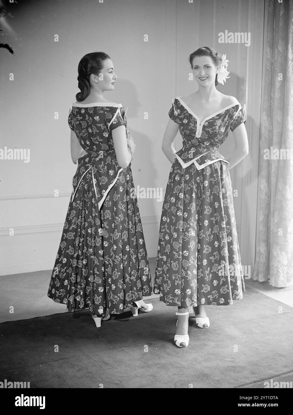 "FASCINO MUSICALE" la presentazione di Anovel idea in fasion è stata ideata da JOY RICARDO che consente alla sua clientela di vedere le modelle sia dal davanti che dal retro. LE IMMAGINI MOSTRANO:- ogni ragazza che indossa questo affascinante vestito caldo "colpisce una nuova nota". Realizzato in puro cotone stampato gay , con un design arpa , è caratterizzato da un corpetto intricato e da un elegante taglio a V , offre un'immagine deliziosa in qualsiasi modo la si guardi. 2 giugno 1948 Foto Stock