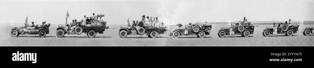 Attraversate il deserto del Gobi fino ad un grande incubatore di dinosauri : auto e cammelli in trekking fino a Flaming Cliffs , Mongolia . Visto qui nella prima auto , il signor Roy Chapman Andrews , capo della spedizione , al volante ; nella seconda auto , Wolf , un cane della polizia di Pechino , che si guadagnò le ossa di carne assumendo la guardia notturna del campo ; e sulla quarta auto , un condor mongolo catturato giovane in un nido su una alta scogliera e collocato nel New York Zoological Park : la carovana motoria della spedizione scientifica americana in Mongolia alla ricerca di uova di dinosauro e di altri tesori paleontologici . 9 gennaio 192 Foto Stock