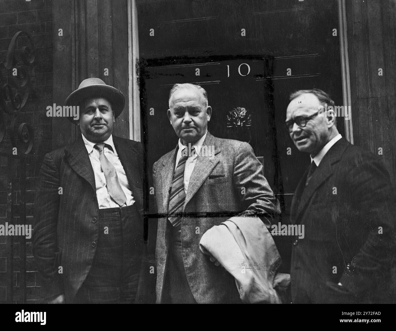 I leader dei minatori, tra cui Will Lawther, presidente dell'Unione nazionale dei minatori, e Arthur Horner, segretario generale, hanno partecipato al n.10 di Downing Street per presentare al signor Attlee il loro piano in quattro punti per aiutare la manodopera. I leader dell'unione intendono sottolineare che c'è stato un calo della possibile forza lavoro per i pozzi e che l'offerta di ex minatori in grado di tornare è quasi esaurita. Foto: Fuori dal numero 10 di Downing Street questo pomeriggio Mr. Will Lawther (a sinistra), Mr. Joseph Hall e Mr. Arthur Horner (a destra), ritratti prima di incontrare Mr Attlee. 30 luglio 1947 Foto Stock