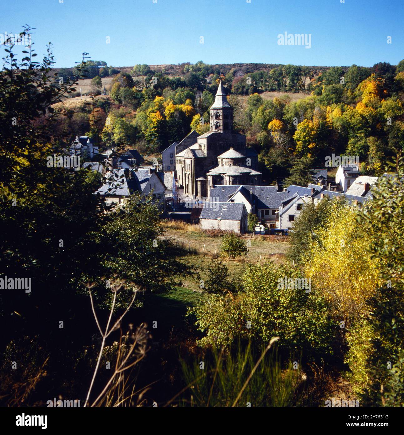 Kirche Notre-Dame als Ortsmittelpunkt der Gemeinde Orcival im Departement Puy de Dome in der Region Auvergne, Frankreich um 1985. Foto Stock