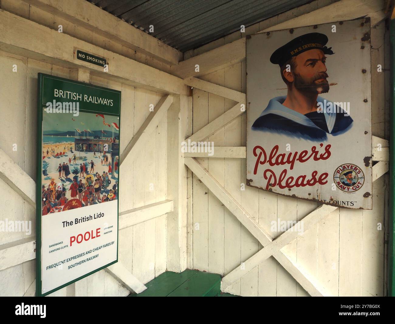 Poster pubblicitari vintage British Railways (BR) e Player's presso Midsomer Norton Station, Somerset. British Rail, viaggi in treno, sigarette, fumo. Foto Stock