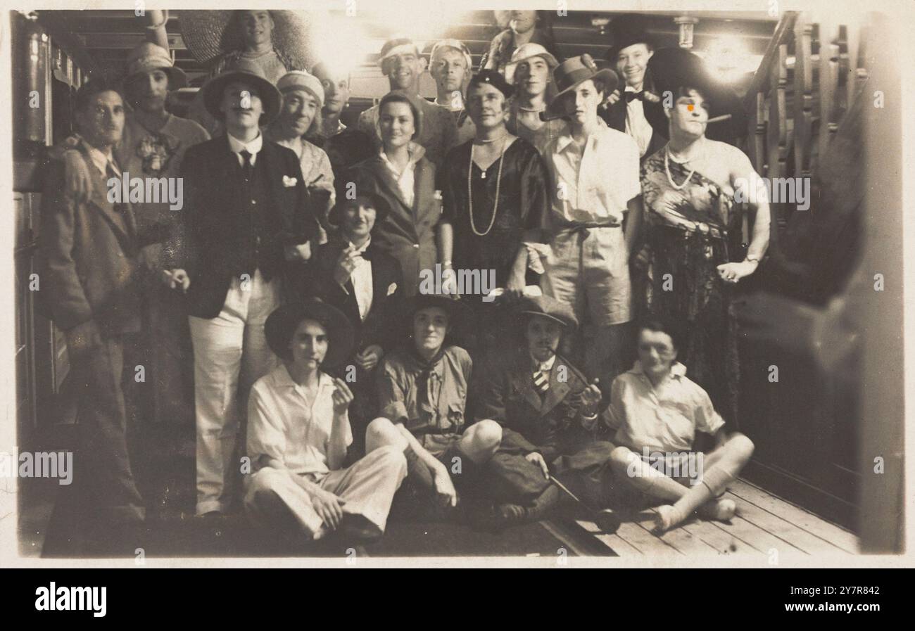 I passeggeri sul RMS Armadale Castle, alcuni in trasloco, posano per un ritratto di gruppo. Cartolina fotografica, 1933. I passeggeri (ed eventualmente l'equipaggio) a bordo della nave che organizzano una festa in costume. Il cross-dressing, come al solito in tali occasioni, era all'ordine del giorno Foto Stock