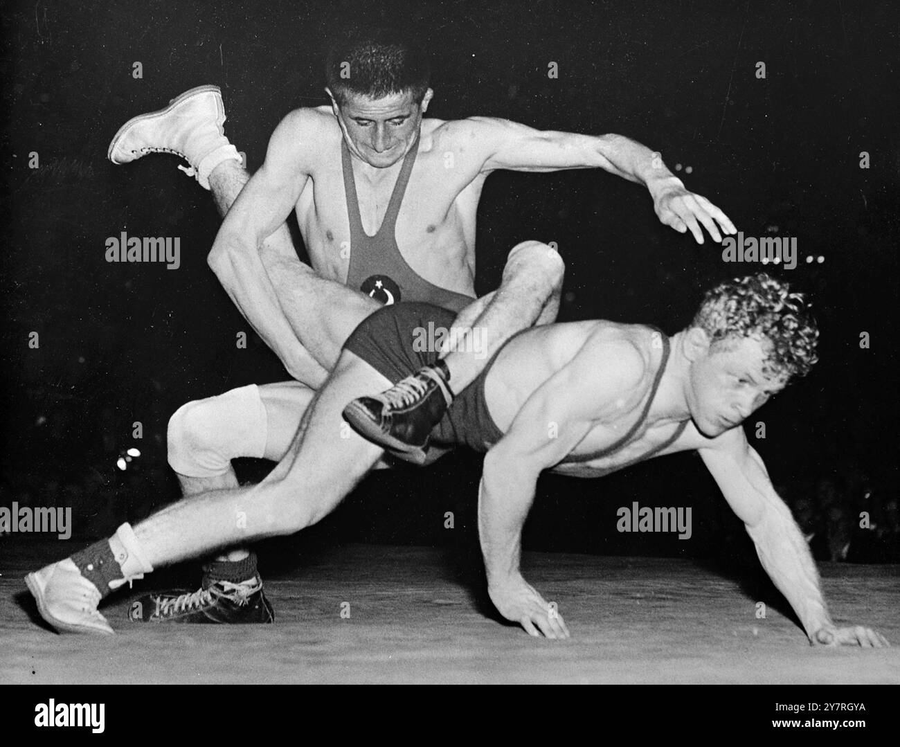 Questo mi sta facendo scendere. Il 13.11.53, la Svezia ha incontrato la Turchia in un incontro internazionale di lotta libera a Stoccolma il mercoledì. La foto INP mostra Akbas della Turchia che sembra praticare per una corsa su carriola mentre spinge Karl Erik Andersson della Svezia sulla tela. 532/PJ/72545. Foto di notizie internazionali. Foto Stock