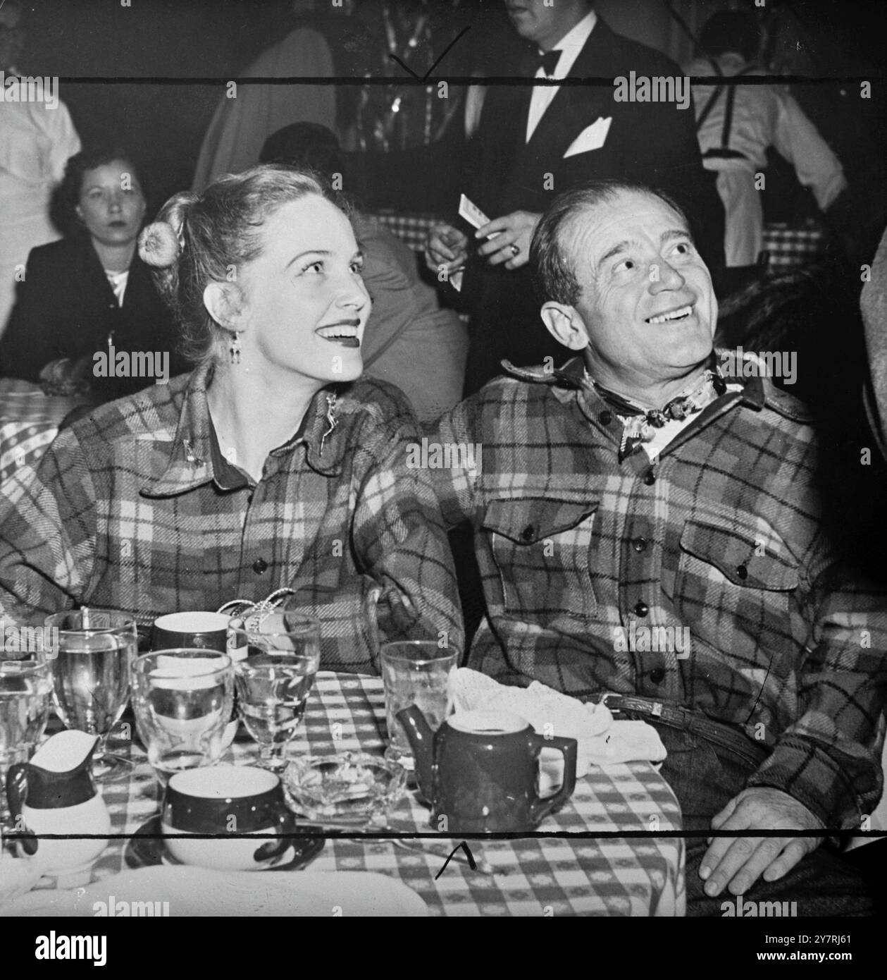 SFAVILLANTI cuori DINERSTwo che battono come uno, due sorrisi che si abbinano in modo accattivante alle camicie a quadri indossate per "chow time" dall'attrice Barbara Britton e da suo marito Eugene Cukor. La coppia indossò il loro abbigliamento non convenzionale per una serata al Ciro's di Hollywood, California, USA, 8 gennaio 1951 Foto Stock