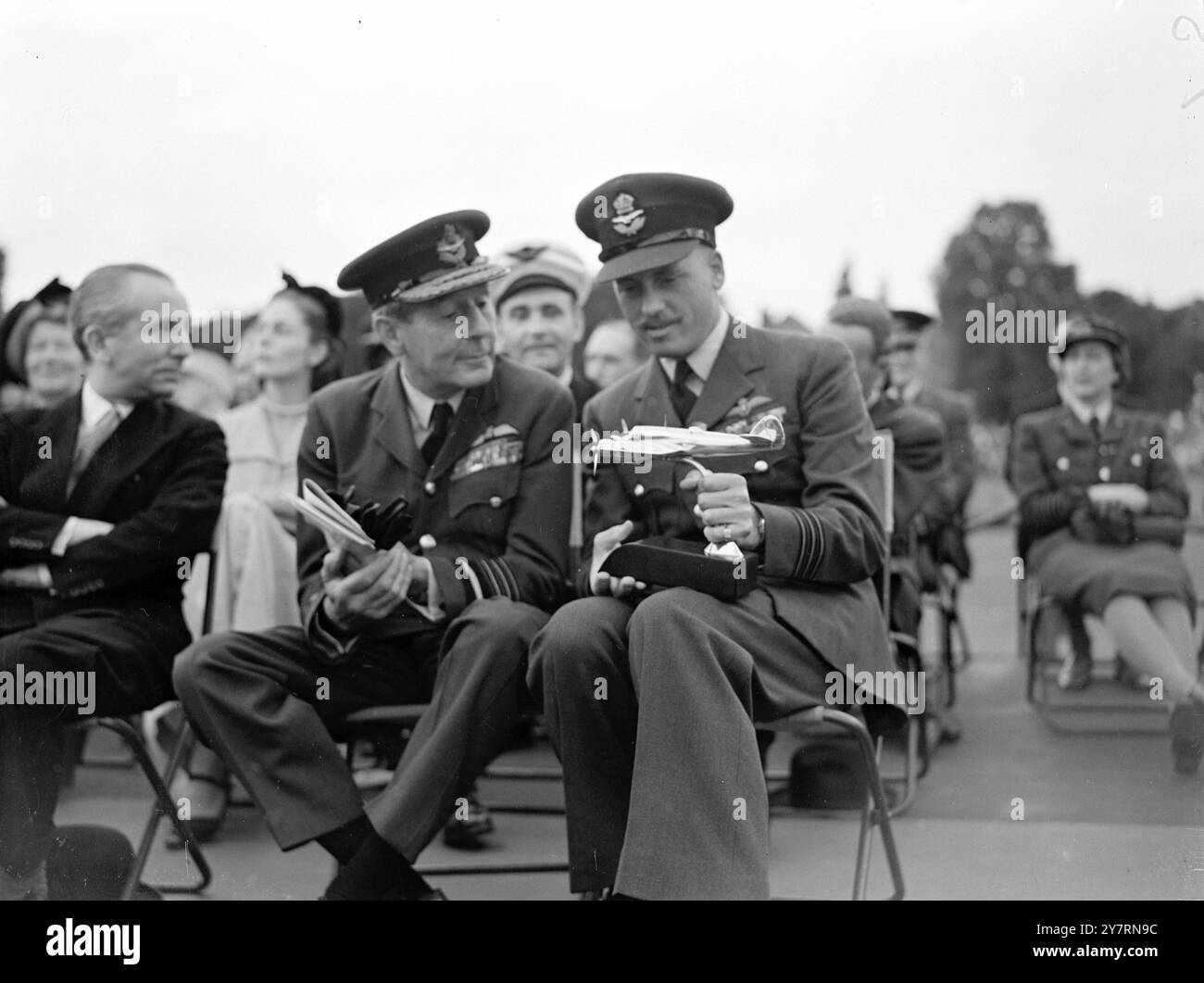HA LASCIATO CADERE IL TRICOLORE SULLA PARIGI OCCUPATA sette anni fa, il comandante Kenneth Gatward, D.S.O., D.F.C., ha volato un Beaufighter appena sopra i tetti di Parigi, poi occupato dai tedeschi, e ha lanciato un tricolore francese sull'Arco di Trionfo. L'exploit è stato ricordato stasera, quando per conto del governo francese, una replica in seta del tricolore gli è stata presentata da MME.J.LUC , testimone oculare del volo. Gli fu anche presentato un modello di colpa del beaufighter usato nella sua pericolosa missione. La cerimonia si è svolta a Broomfield Park, Southgate, Londra, e successivamente al Wing Commander Gatward Foto Stock