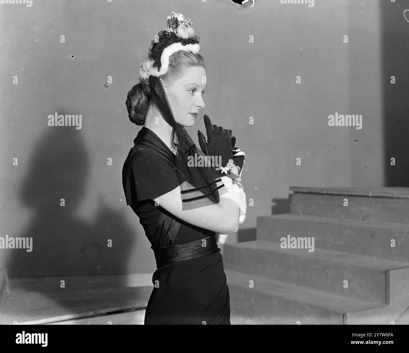 Il LONDON MILLINERS MOSTRA I CAPPELLI DELLA VITTORIA AL MONDO gli acquirenti da tutto il mondo erano presenti nel teatro Saville, a Londra, per vedere una sfilata di moda di 90 cappelli disegnati dai principali produttori londinesi. I modelli sono stati scelti dal lavoro di 28 designer. Spettacoli fotografici: Un cofano vittoriano di ermellino bianco rifinito con pizzo nero e rifinito con una rosa e bianca veste vittoriana. i guanti sono fatti per essere abbinati. 28 maggio 1946 Foto Stock