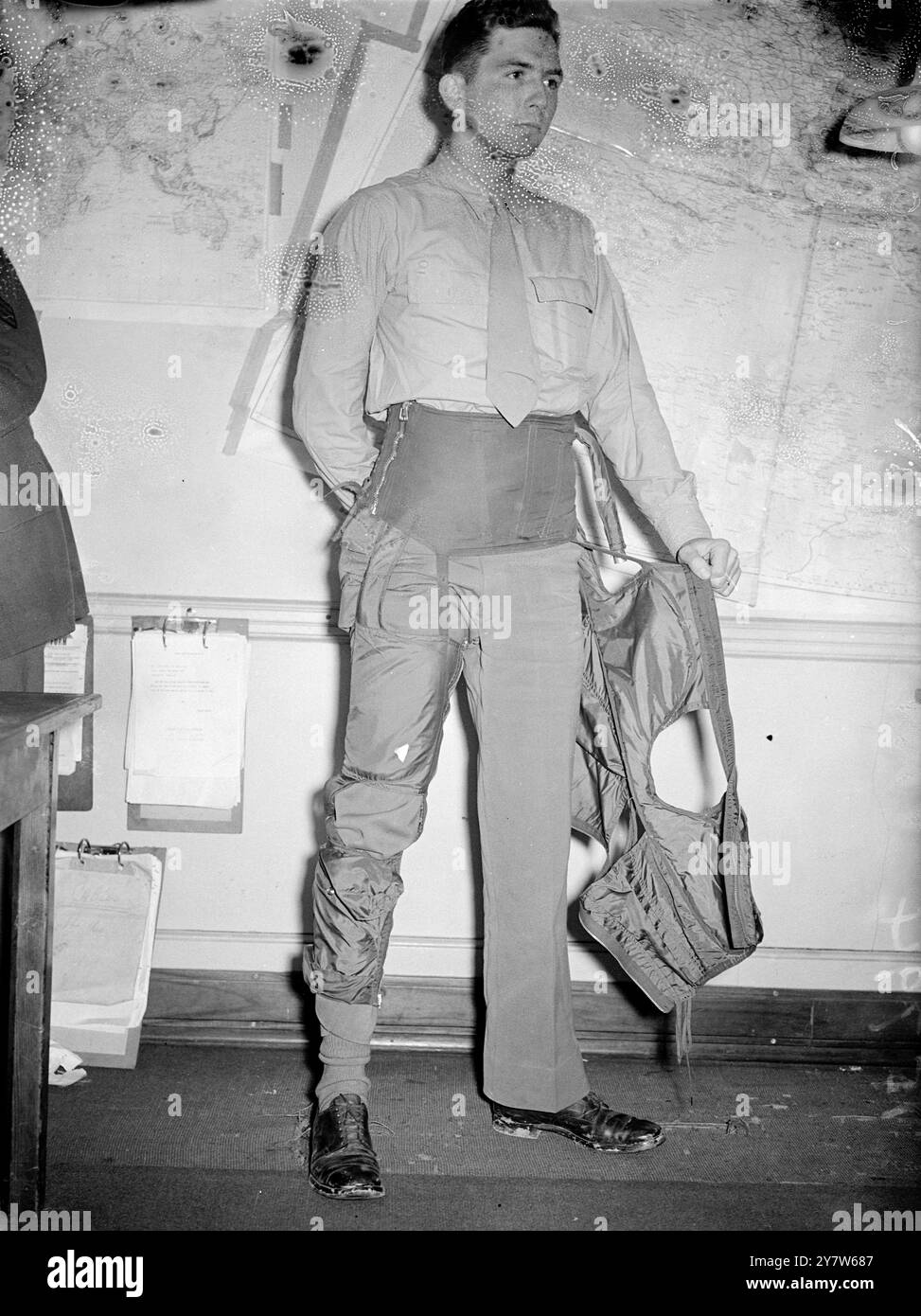 LE TUTE ANTI-GRAVITÀ IMPEDISCONO AI PILOTI DEGLI AMERICAN FIGHTER DI "DISTRUGGERE" i piloti di caccia americani stanno usando tute anti-gravità per evitare "oscuramento" quando i loro aerei escono da immersioni ripide. Aderendo saldamente ai vitelli delle gambe, delle cosce e dell'addome, la tuta è dotata di una valvola automatica che agisce dallo scarico dell'aeromobile, esercitando pressione sulla metà inferiore del corpo e impedendo al sangue di fuoriuscire dal cervello durante un'immersione. Spettacoli fotografici: Il Capitano Donald W Johnson, 24 anni di Detroit, Michigan, ha distrutto tre aerei della Luftwaffe indossando una tuta anti-gravità in una Foto Stock