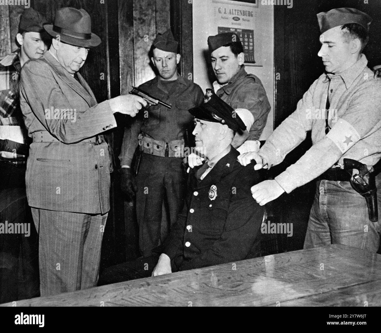 I Red Raiders conquistarono il potere nella città degli Stati Uniti più tardi nella campagna anticomunista di Amrica , fu un realistico raid nella città di Mosinee , Wisconsin , da parte delle forze rosse , che spararono al capo della polizia , trascinarono il sindaco fuori dal letto e lo costrinsero a dichiarare la città sotto il dominio comunista , e gettarono molti cittadini in un campo di concentramento . Spettacoli fotografici: Il "compagno" Ben Gitlow, uno dei Legionari americani, che ha organizzato il "raid rosso", si prepara a sparare al capo della polizia Mosinee, Carl Gowiss, per il rifiuto di cooperare con le forze comuniste. 3 maggio 1950 Foto Stock