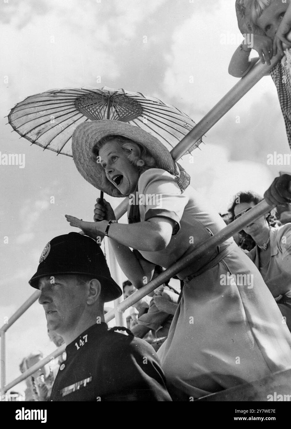 L'elmetto di Constable A Devonshire mantiene la posizione nonostante i movimenti eccitati di una spettatrice Mrs J Buckman di Remuera Auckland nuova Zelanda. Empire Games 1950 Foto Stock