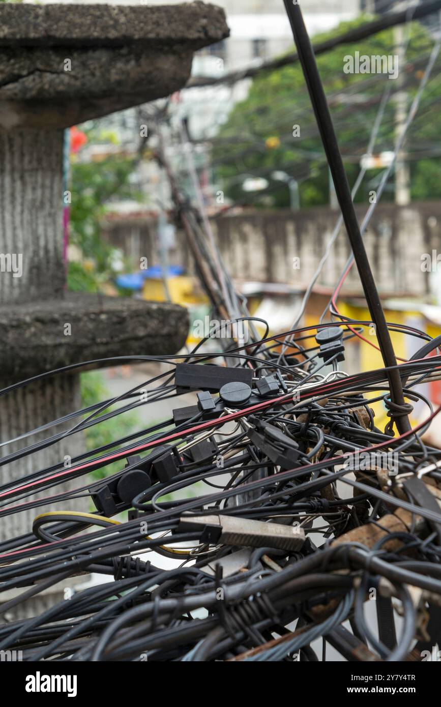 Guardando dall'alto, si trova al primo piano e all'angolo della strada. Molti cavi metallici complessi e frastagliati che corrono lungo le strade laterali in un sobborgo della Foto Stock