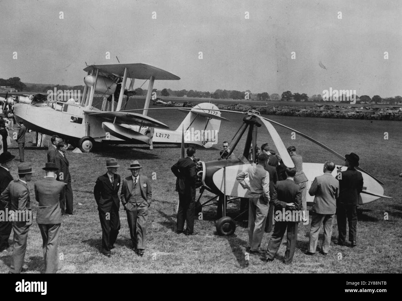 Flying display and Exhibition all'Hatfield Aerodrome -- la nostra fotografia mostra il giroaereo monoposto Hafner firmato dal signor Hafner, un ingegnere austriaco. ***** in questo paese si sta attivamente sviluppando una nuova forma di giroaereo. Incarna un ***** metodo di controllo del rotore. L'altro aeroplano nella foto è il biplano anfibio Supermarine Walrus che è stato fornito il Fleet Air Arm e al Torneo Australiano, realizzato alla Vickers Supermarine Aviation ***** . Il "Walrus" è stato il primo idrovolante per barche ***** con successo attraverso processi di catapultazione. 9 agosto 1937. Foto Stock
