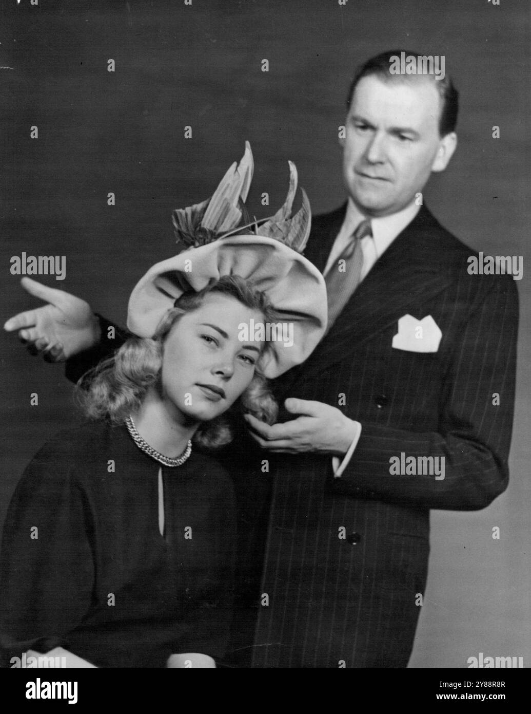 I nuovi modelli di Hugh Beresford sono tutti progettati per essere indossati con capelli corti. Pensa che i capelli diventeranno ancora più corti. Per mostrare cosa significa bugia sul suo design per capelli corti, ha messo questo modello su Diana Gregory dai capelli lunghi. Risultato: Il cappello ha perso la sua linea. 12 marzo 1949. Foto Stock
