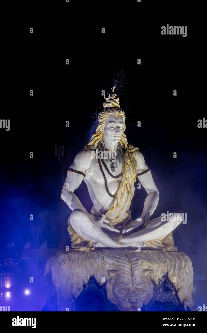 suggestivo idolo del dio santo indù, signore shiva, seduto in mediazione all'aperto di notte Foto Stock