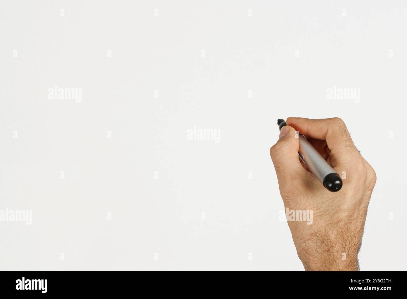 Un uomo che scrive con un pennarello nero isolato sul bianco. Spazio per il testo. Foto Stock