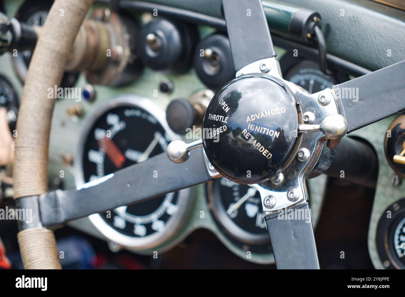 Primo piano di un volante con cambio manuale e vista del vecchio cruscotto di un'auto da corsa d'epoca. Foto Stock