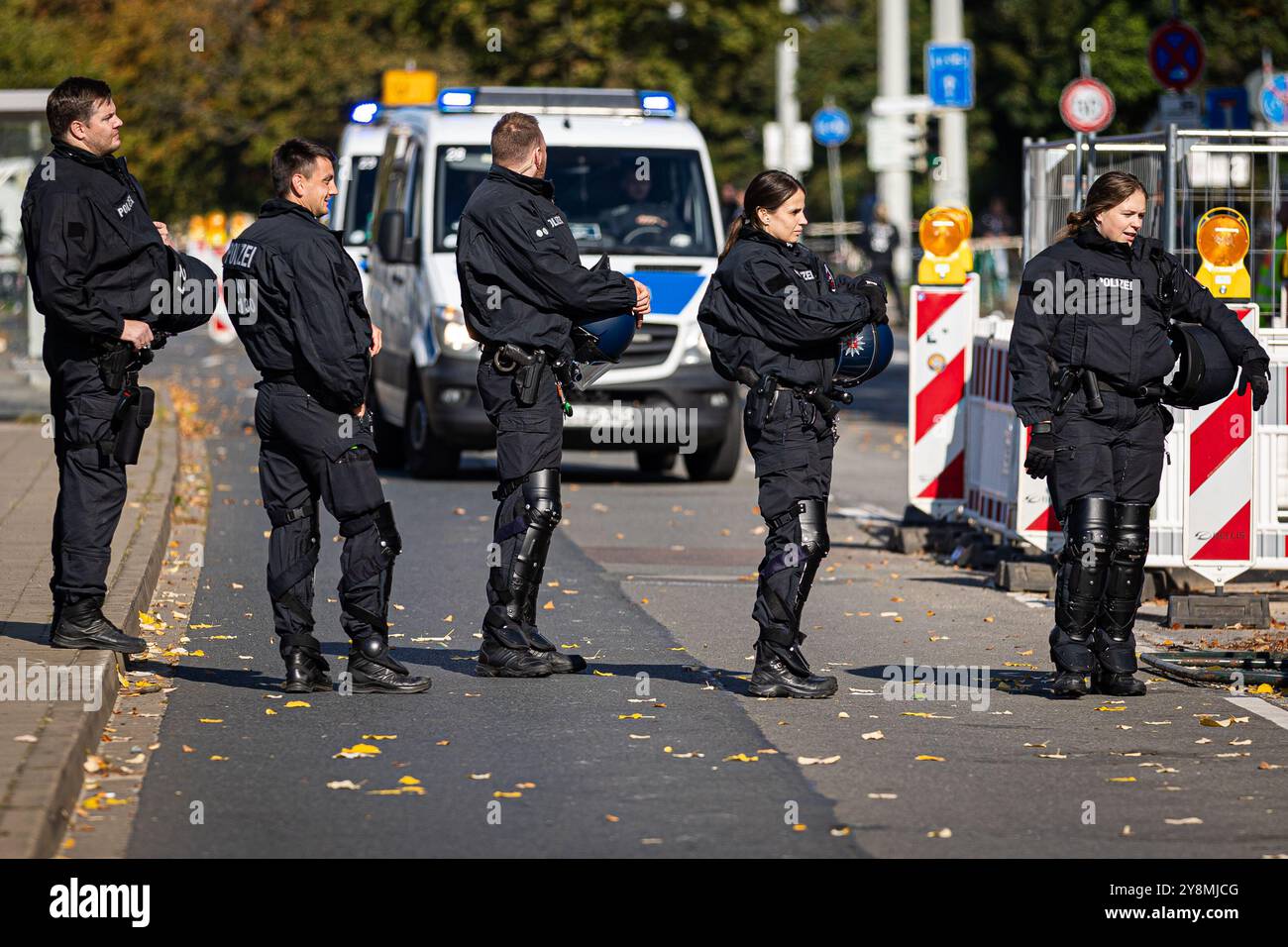 Brunswick, Germania. 6 ottobre 2024. Calcio: Bundesliga 2, Eintracht Braunschweig - Hannover 96, Matchday 8, Eintracht Stadium. Le forze di polizia bloccano una strada di fronte allo stadio. Credito: Moritz Frankenberg/dpa - NOTA IMPORTANTE: In conformità con le normative della DFL German Football League e della DFB German Football Association, è vietato utilizzare o far utilizzare fotografie scattate nello stadio e/o della partita sotto forma di immagini sequenziali e/o serie di foto video./dpa/Alamy Live News Foto Stock