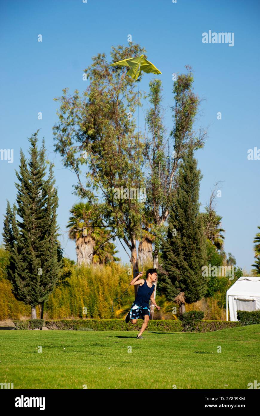 Un ragazzo che corre su un campo verde con un Foto Stock