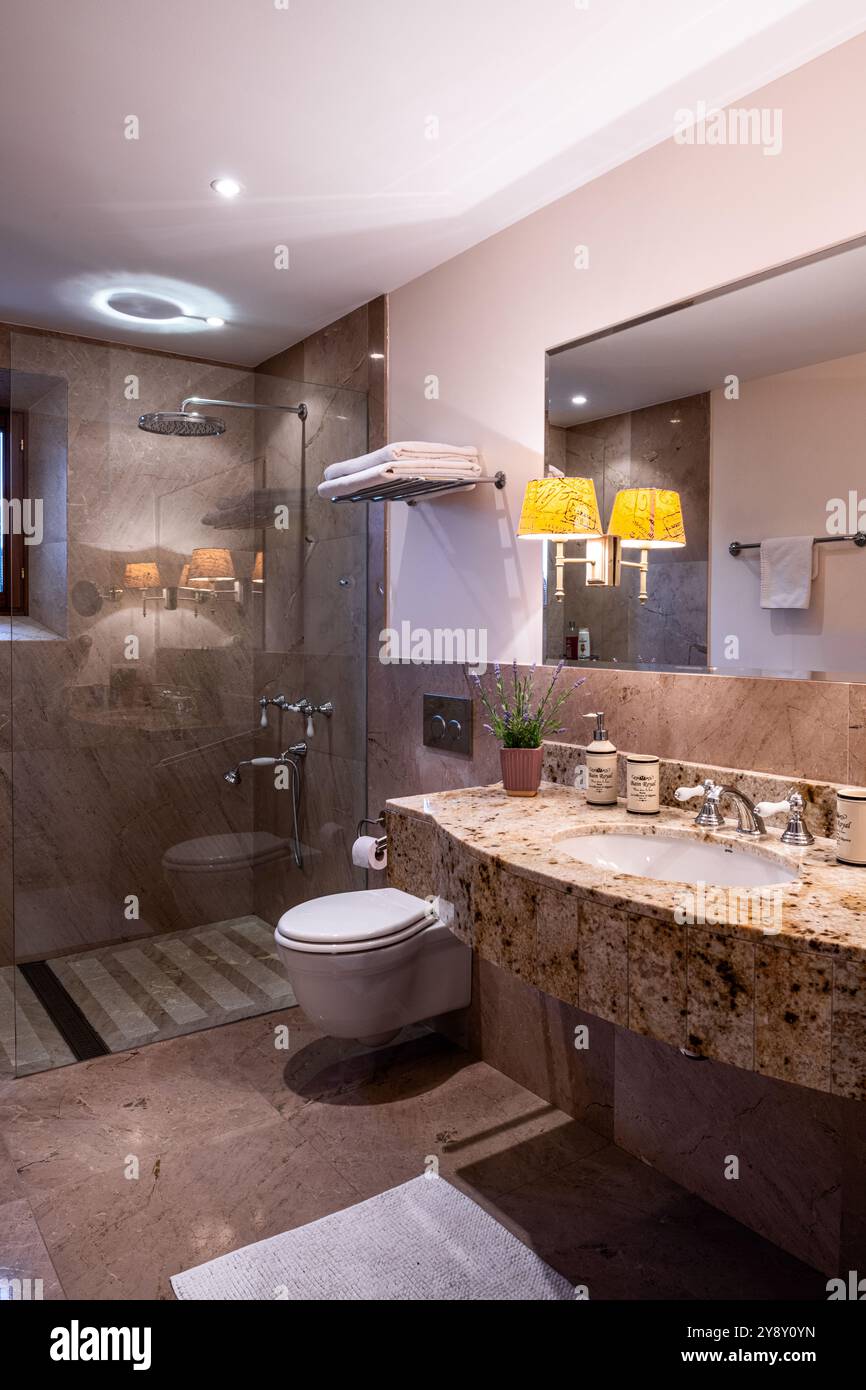Specchio sopra il lavandino in marmo con WC e doccia nella villa spagnola di Maiorca. Foto Stock
