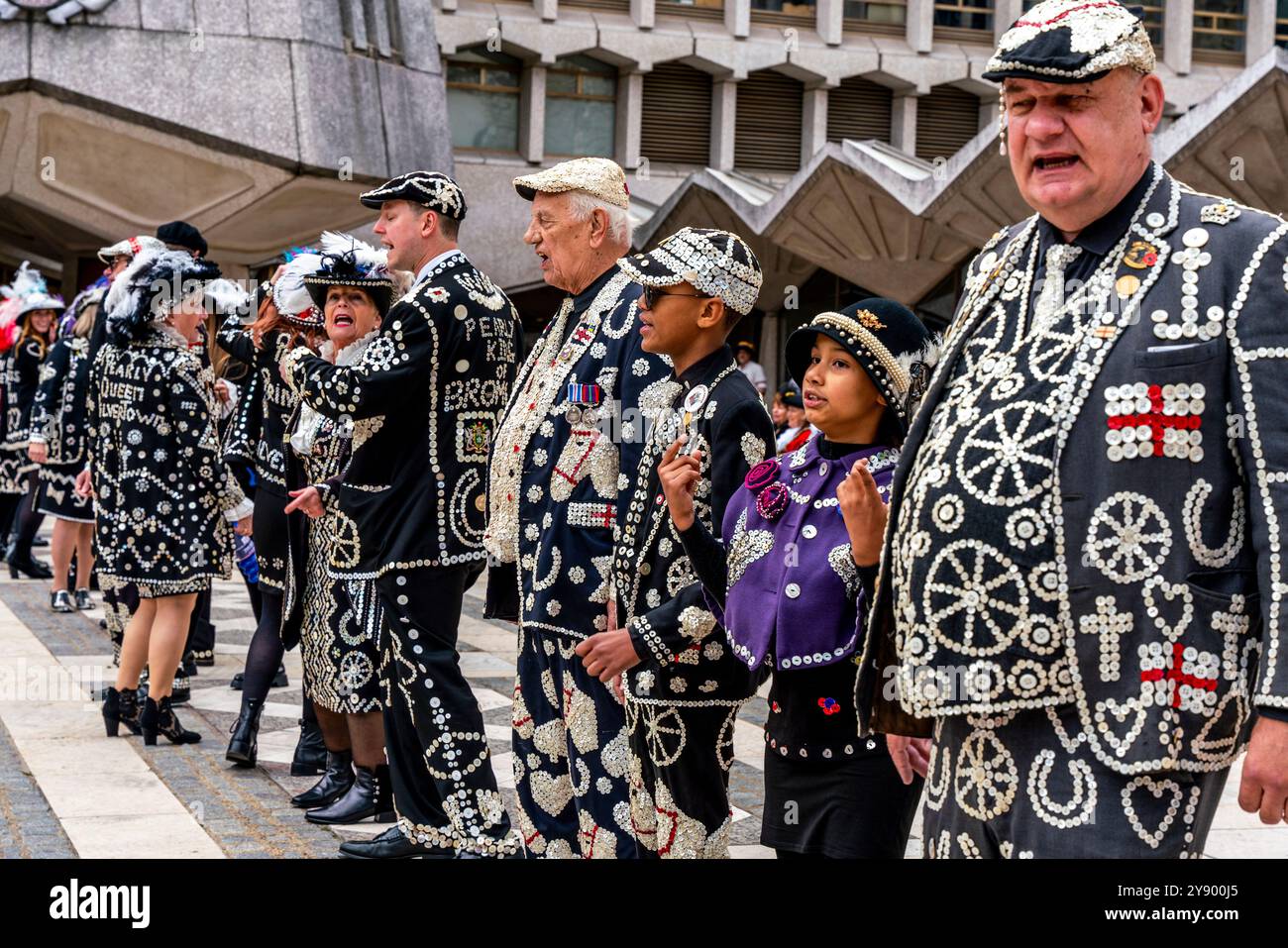 Un gruppo di Pearlies che canta canzoni tradizionali all'Annual Pearly Kings and Queens Costermongers Harvest Festival, The Guildhall Yard, Londra, Regno Unito. Foto Stock