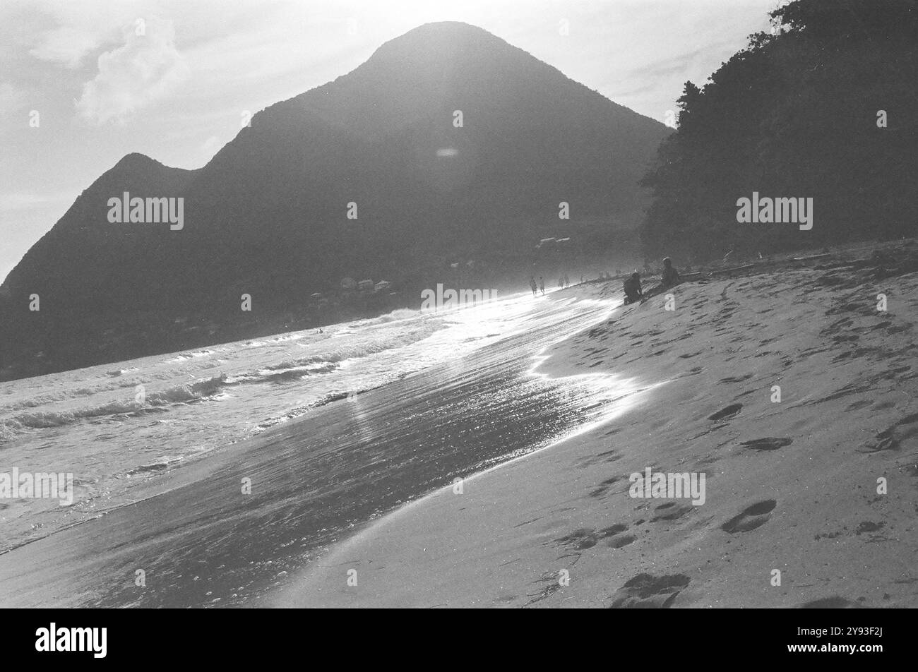 Spiaggia di costa Martinica con montagne vulcaniche sullo sfondo Foto Stock