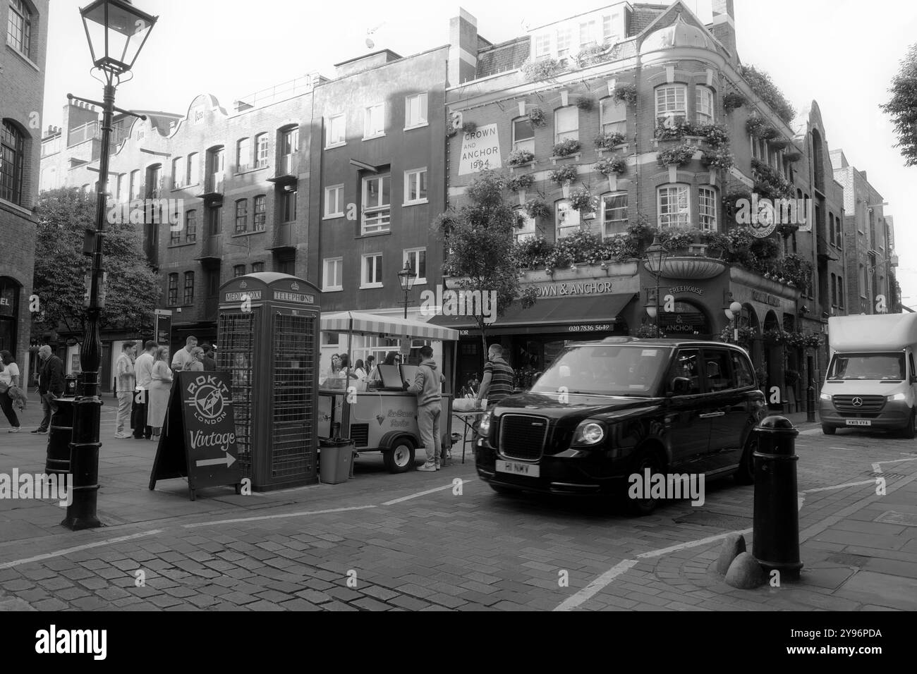 Taxi di Londra in auto da un fornitore di pub e strada. Foto Stock