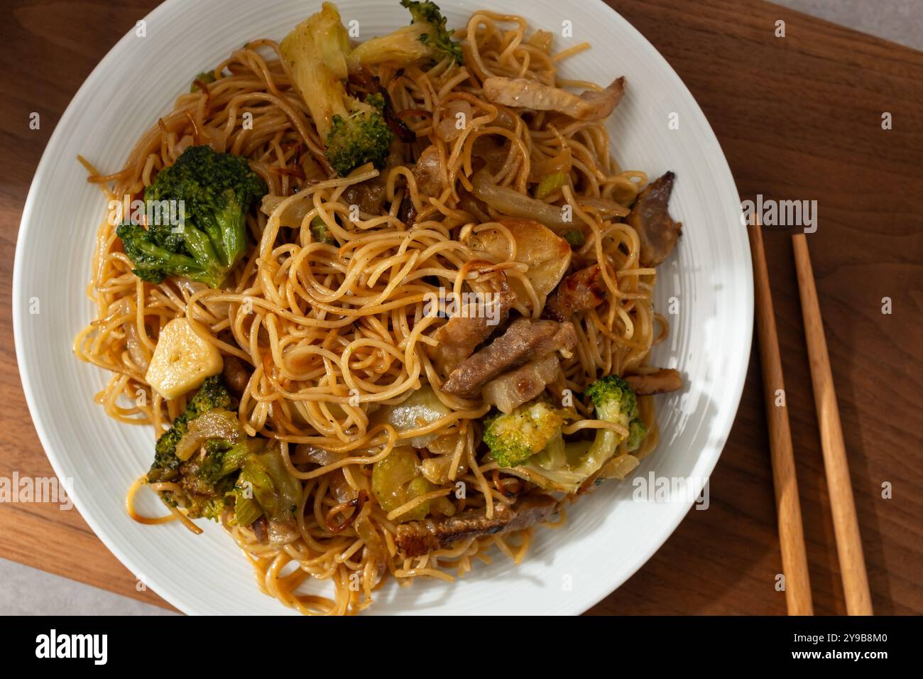 Spaghetti all'uovo in stile Hong Kong saltati in padella con carne e verdure Foto Stock