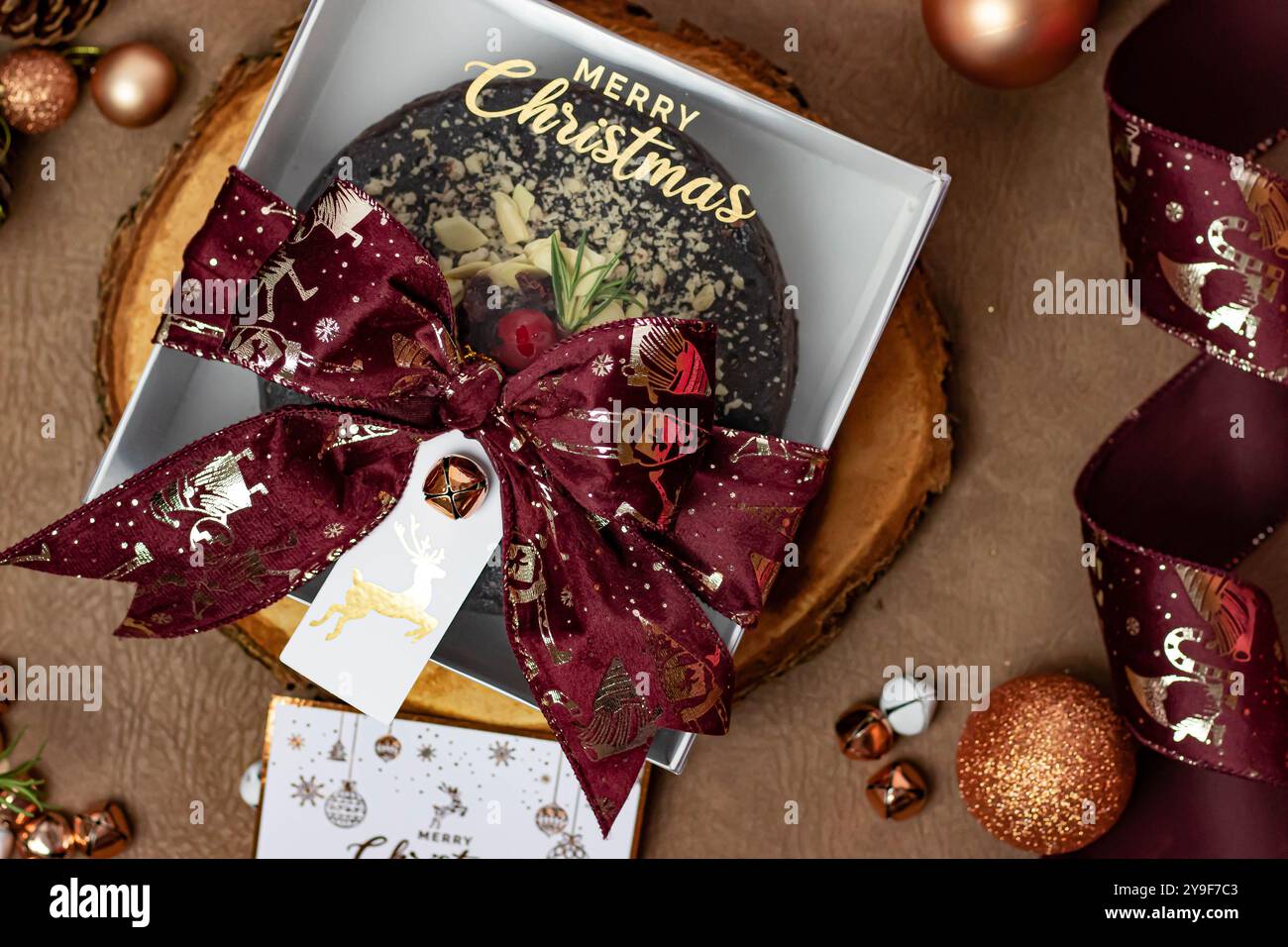 Torta di Natale in una confezione regalo con nastro in velluto Bordeaux Foto Stock