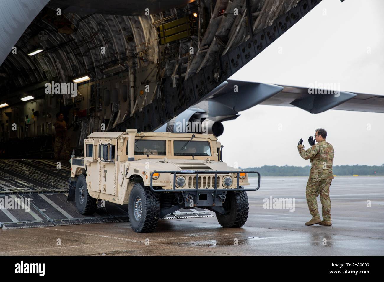 Albert Rein, assegnato al 137th Airlift Squadron, 105th Airlift Wing, guida un veicolo a ruote multiuso ad alta mobilità da un C-17 Globemaster III all'aeroporto Cecil di Jacksonville, Florida, 9 ottobre 2024. Le guardie nazionali dell'aviazione e dell'esercito di New York sono state recentemente mobilitate per sostenere le comunità in Florida colpite dall'uragano Milton. (Foto della Guardia Nazionale dell'Esercito degli Stati Uniti di Joseph Liggio) Foto Stock