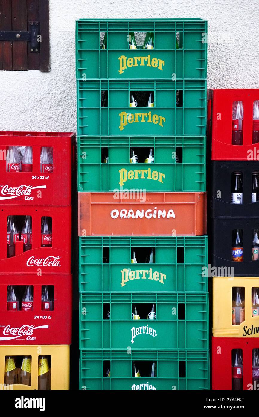 Casse impilate di varie bevande come Perrier, Coca-Cola, Orangina e Schweppes, pronte per la distribuzione o lo stoccaggio in un bar o caffetteria. Foto Stock