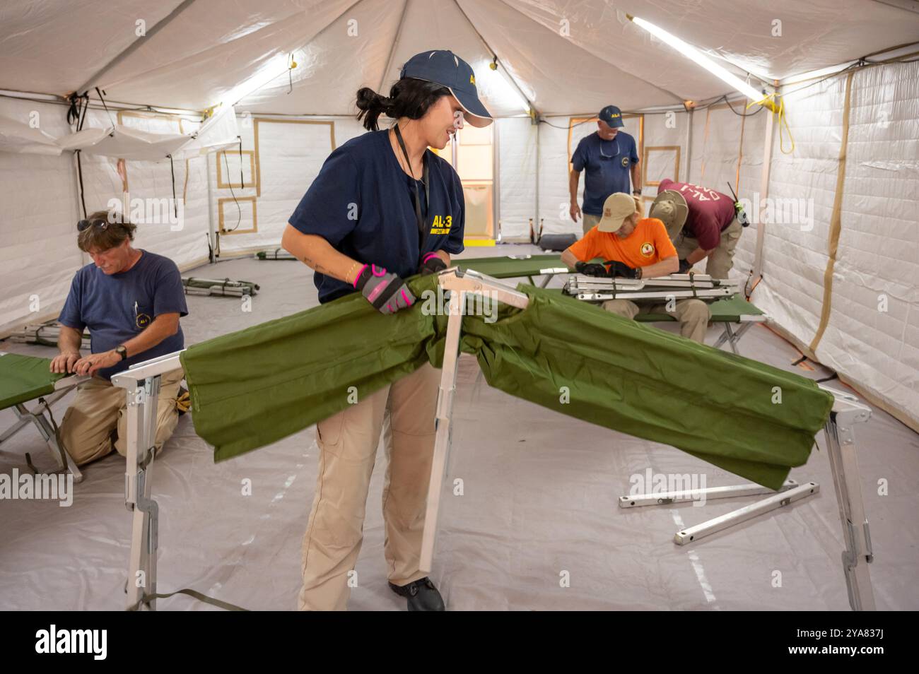 Tampa, Stati Uniti. 11 ottobre 2024. I dipendenti del team di assistenza medica in caso di disastri con il dipartimento servizi sanitari e umani riuniscono le culle mentre costruiscono un ospedale temporaneo per le vittime dell'uragano Milton, 11 ottobre 2024 a Tampa, Florida. L'uragano Milton sbarcò a Siesta Key, come uragano di categoria 3. Crediti: Liz Roll/FEMA Photo/Alamy Live News Foto Stock