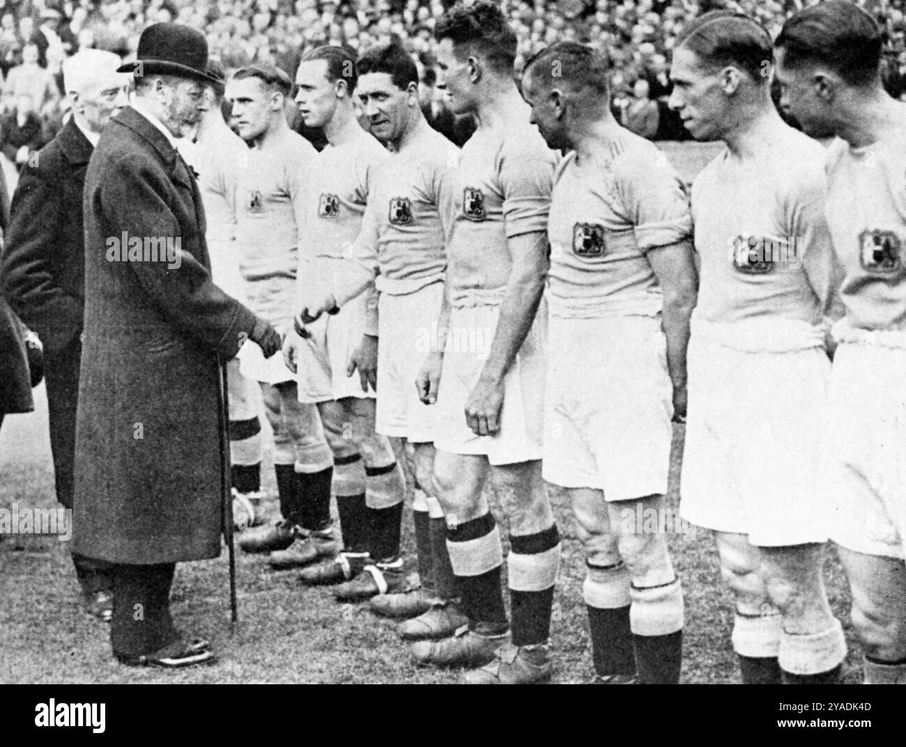 Re Giorgio V stringe la mano alla squadra del Manchester City in vista della finale della Coppa del 1926, Wembley Stadium, Londra. I giocatori, i funzionari delle partite e i presidenti dei club furono presentati a King George V (1865-1936), prima della finale di Coppa del 1926, in cui il Bolton Wanderers batté il Manchester City per 1-0. Foto Stock