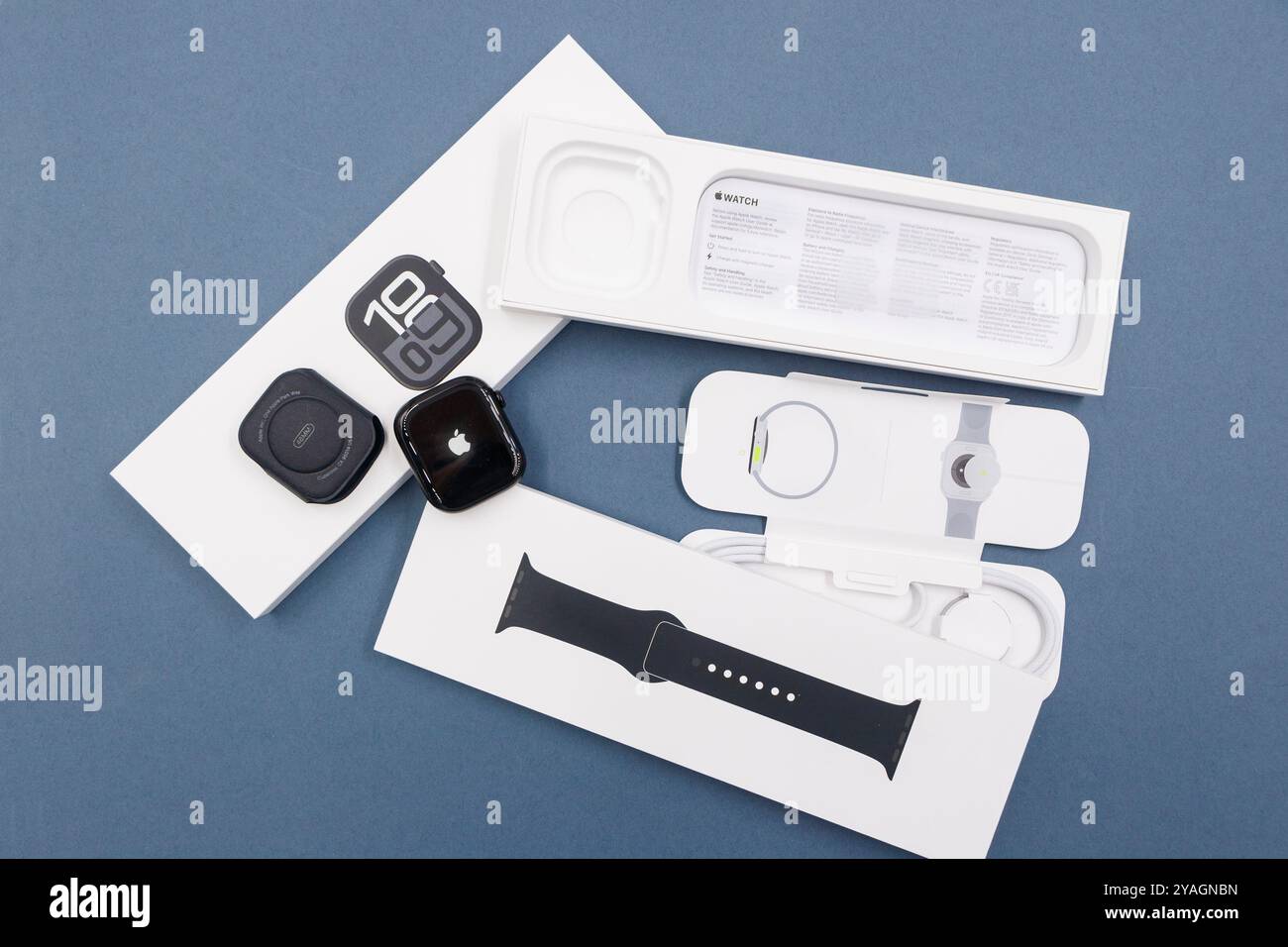 Confezione con la nuova configurazione dello smartwatch Apple Watch serie 10 del 2024, unboxing e braccialetto intercambiabile su sfondo blu Design elegante Foto Stock