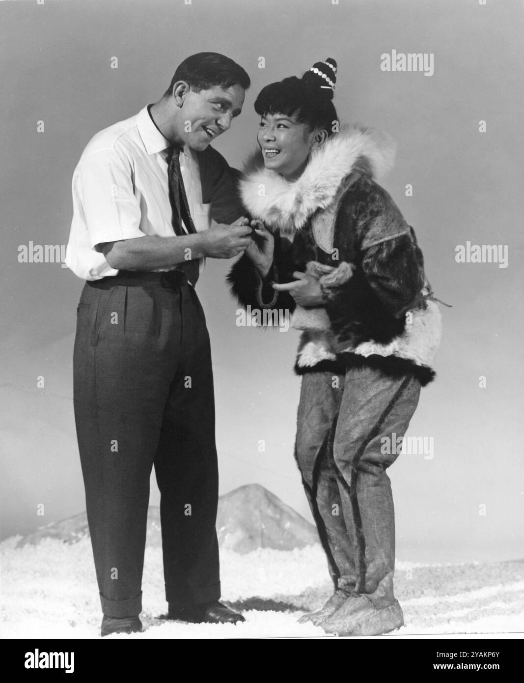 NORMAN WISDOM Visiting JAPANESE Actress YOKO TANI sul set di THE SAVAGE INNOCENTS ai Pinewood Studios 1960 regista NICHOLAS RAY Novel HANS RUESCH Fotografia di GEORGE COURTNEY WARD Societe Nouvelle Pathe Cinema / Appia Films / Gray-Film / Magic Film / The Rank Organization Foto Stock