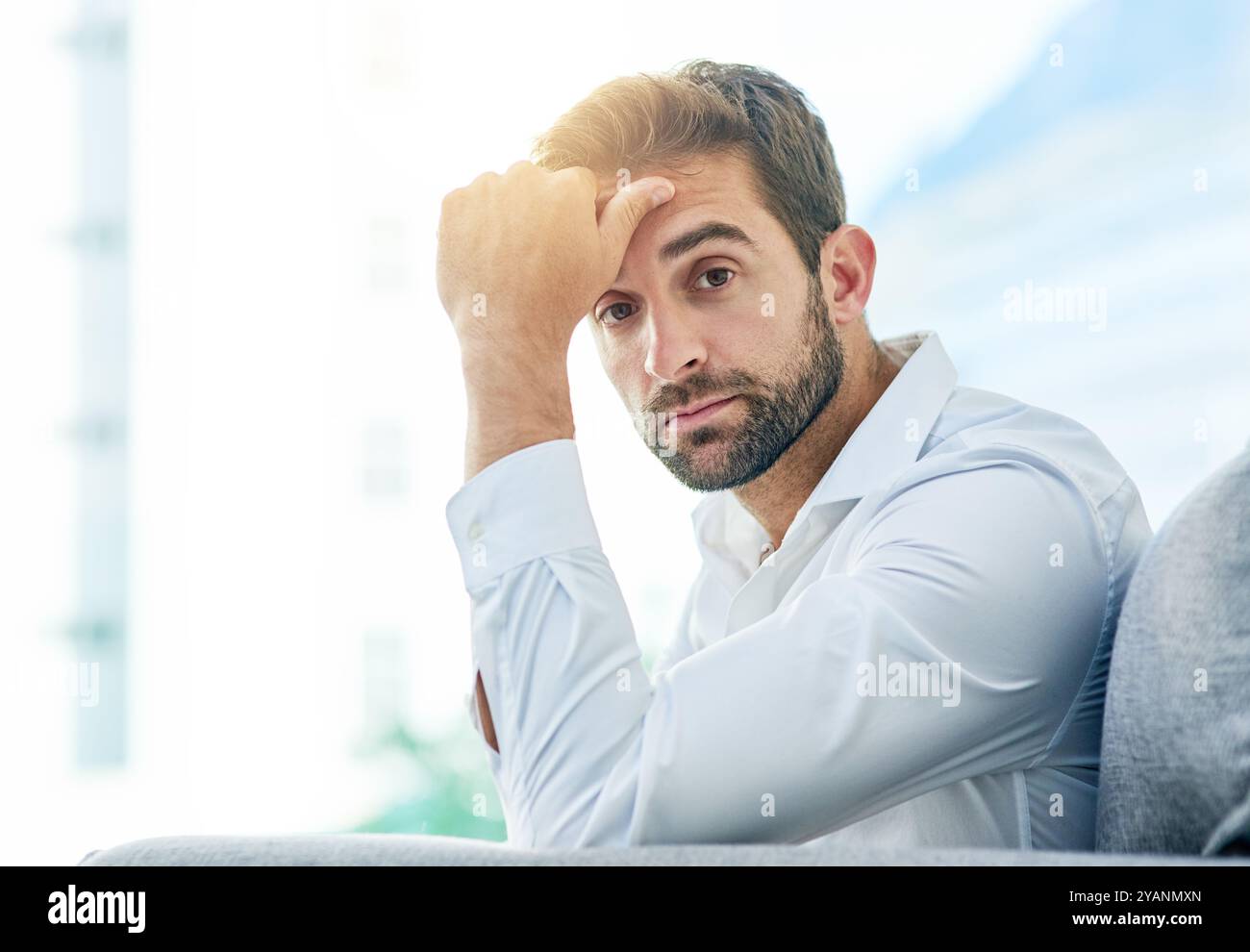 Uomo d'affari, ritratto e pensiero serio in ufficio, idea e contemplazione di opportunità di crescita. Uomo, professionista e pausa sul divano Foto Stock