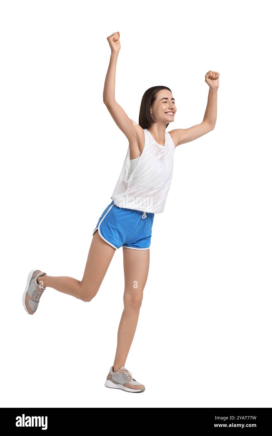 Bella donna in abbigliamento sportivo che corre su sfondo bianco Foto Stock