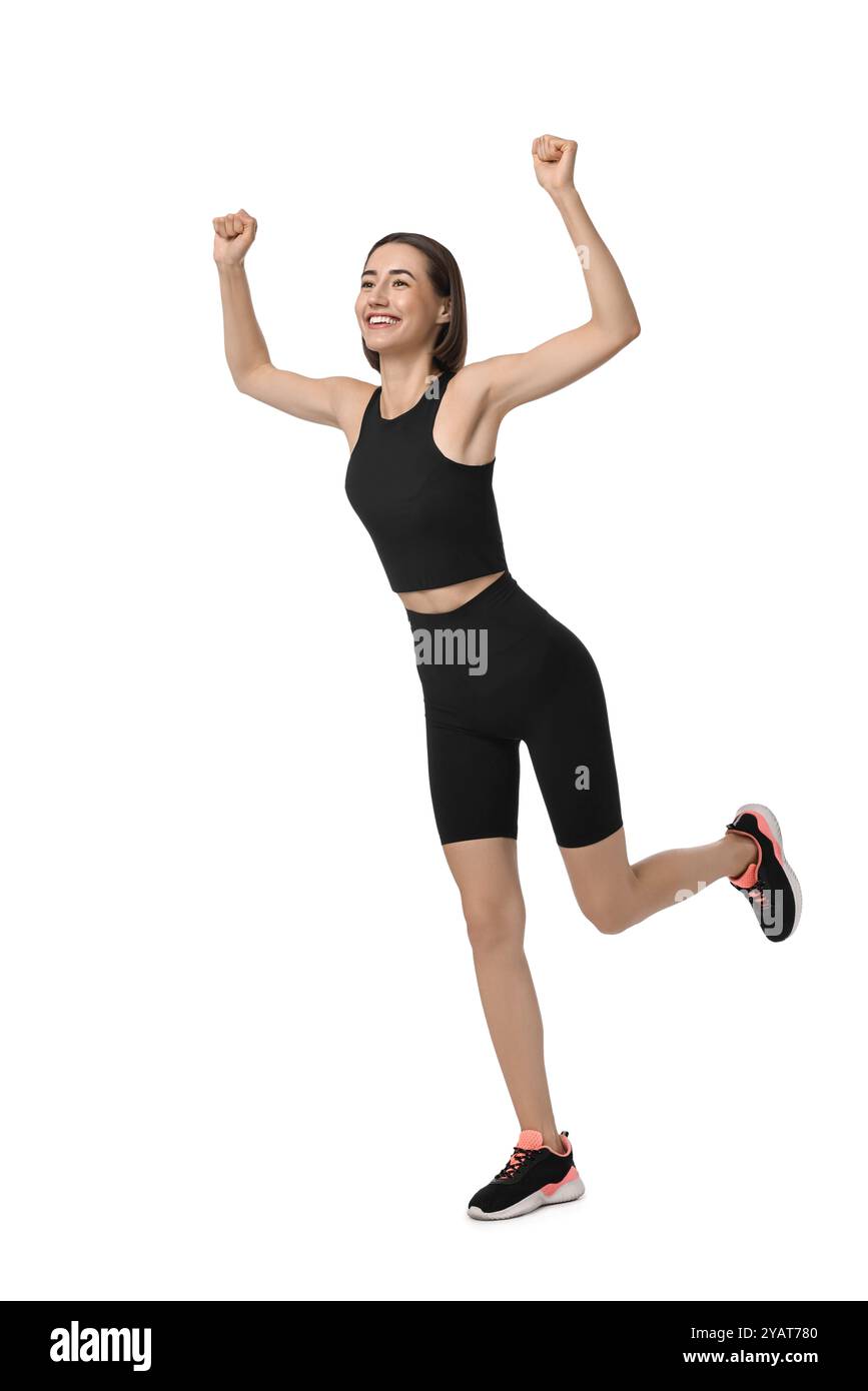 Bella donna in abbigliamento sportivo che corre su sfondo bianco Foto Stock