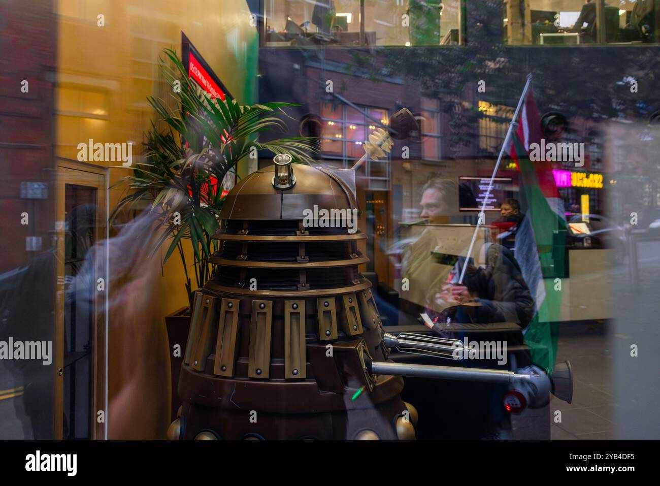 Leeds, Regno Unito. 16 OTTOBRE 2024. Dalek, di lunga data della BBC show Doctor Who, accanto alle riflessioni della bandiera palestinese come manifestanti, ha organizzato una dimostrazione fuori dagli uffici della BBC Yorkshire nel centro di Leeds accusandoli di parzialità nella copertura del conflitto di Gaza. C'era una presenza significativa della polizia e i manifestanti non sono entrati. A seguito di ciò i manifestanti si trasferirono alla stazione degli autobus di Leeds, dove un uomo era dirompente e presumibilmente assalì uno dei manifestanti, portando a parlare con entrambi gli uomini dalla polizia, non ci furono arresti. Credito Milo Chandler/Alamy Live News Foto Stock