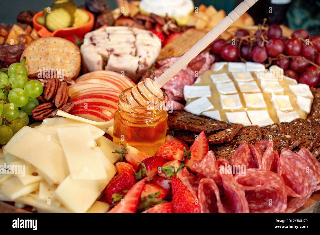 Salumi e formaggi abbondanza di formaggi assortiti, carne, noci e frutta da una vista laterale Foto Stock