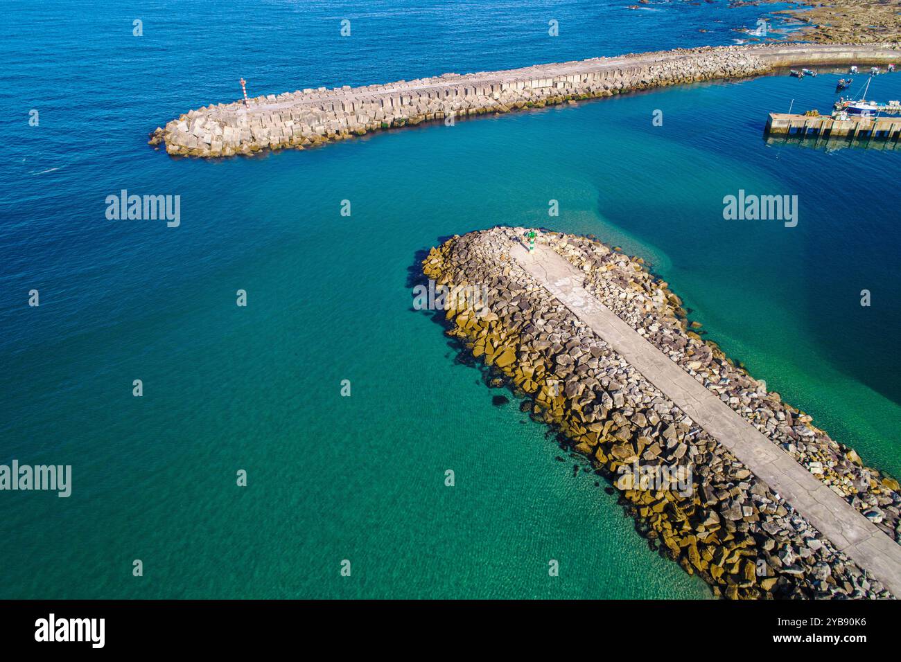 frantumazione di blocchi di cemento e cemento all'ingresso di un porto marittimo in estate, vista aerea dei droni Foto Stock