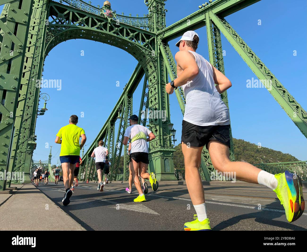 Vista posteriore del gruppo atleti che corrono il ponte Freedom a Budapest Foto Stock