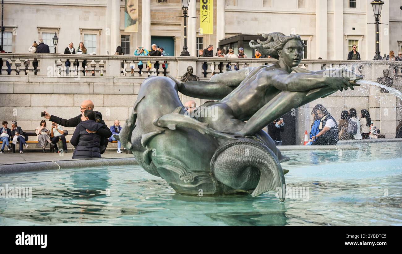 Londra, Regno Unito. 18 ottobre 2024. I turisti possono scattare selfie su Trafalgar Square al caldo sole. A seguito di nebbia e nebbia precedenti, il sole e le temperature molto miti dominano per tutto il pomeriggio nel centro di Londra credito: Imageplotter/Alamy Live News Foto Stock