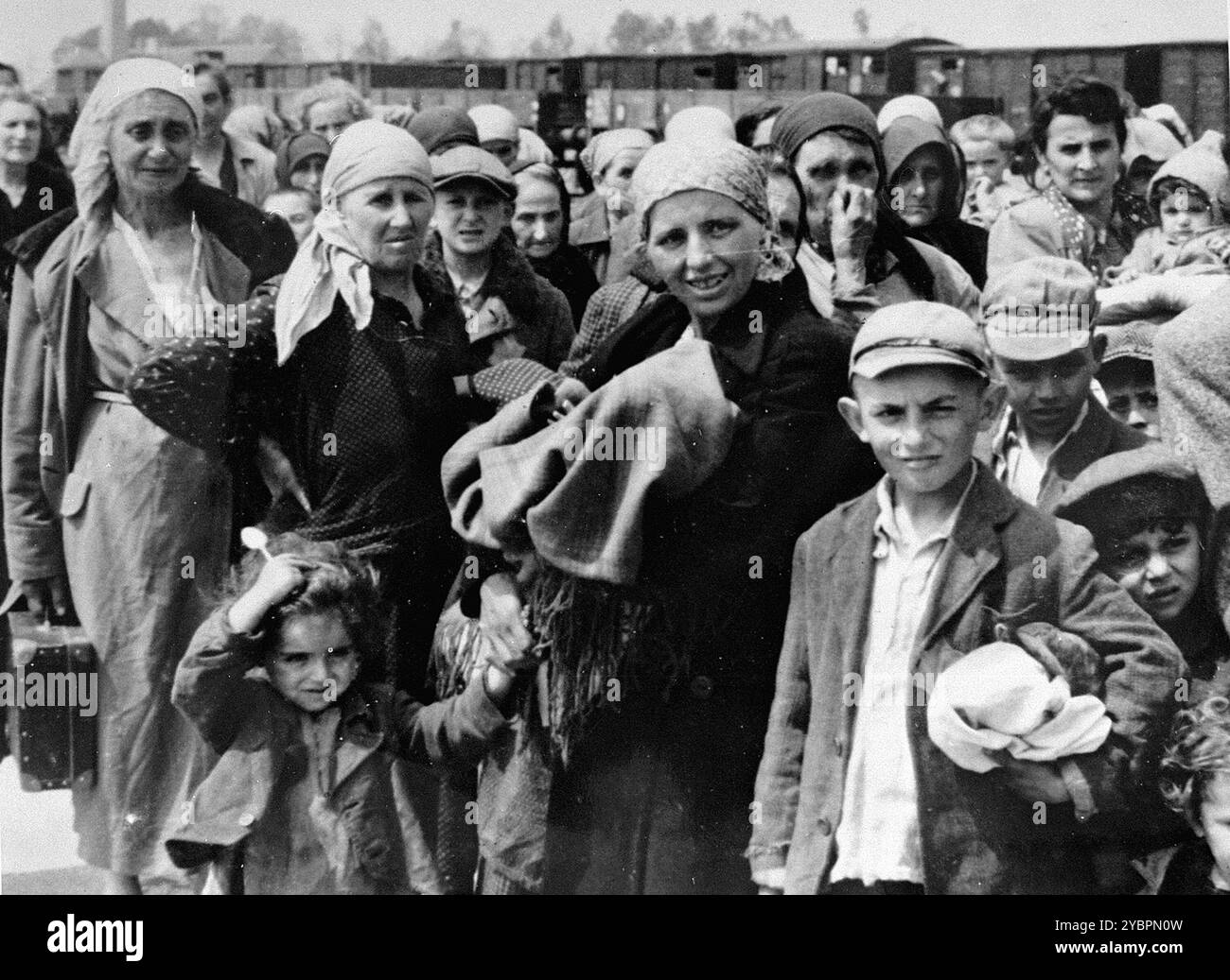 Donne e bambini ebrei dall'Ungheria attendono la selezione sulla rampa di Auschwitz. Gli ebrei in Ungheria erano abbastanza al sicuro fino a quando Hitler, temendo che l'Ungheria stesse cercando un accordo con gli alleati, ordinò l'invasione del paese nel marzo 1944. Tra il 15 maggio e il 9 luglio 1944, oltre 434.000 ebrei furono deportati su 147 treni, la maggior parte dei quali ad Auschwitz, dove circa il 80% fu gassato all'arrivo. I rapidi progressi delle deportazioni sono stati resi possibili da una stretta cooperazione tra le autorità ungheresi e tedesche. Foto Stock