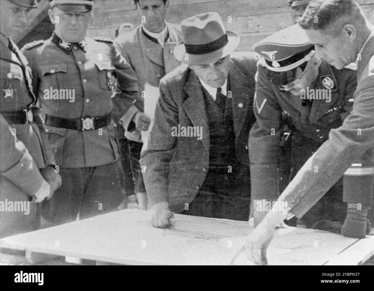 Il Reichsfuehrer SS Heinrich Himmler esamina un piano di costruzione con Max Faust (indossando la fedora) durante un tour di ispezione del sito di costruzione di Monowitz-Buna. Foto Stock