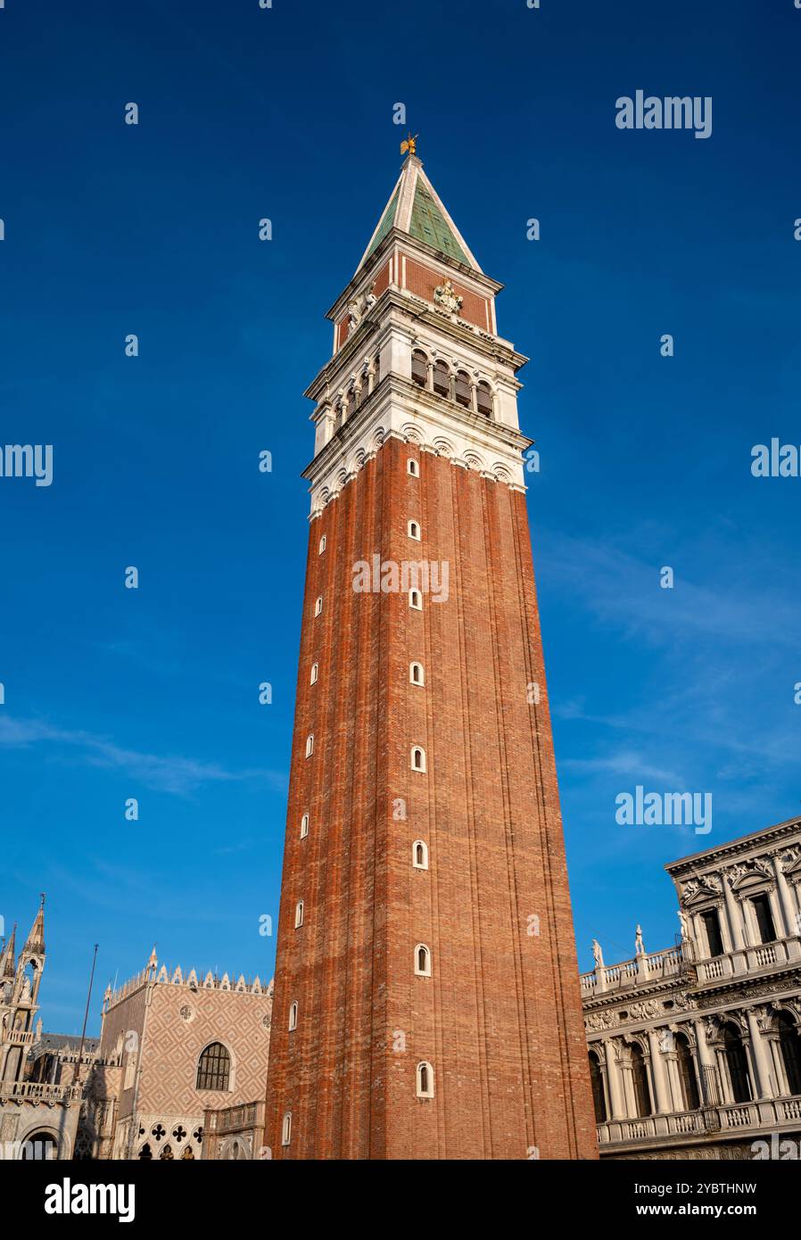 La struttura più alta del Campanile di Piazza San Marco a Venezia, in Europa, con vecchi edifici sotto il cielo blu Foto Stock