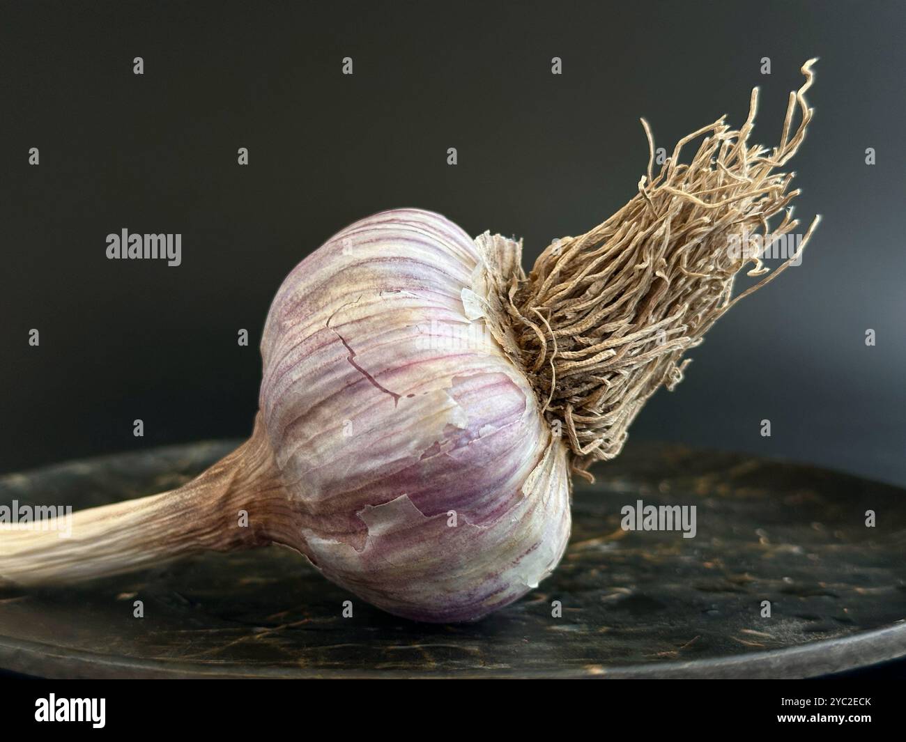 aglio in un piatto con fondo marrone Foto Stock