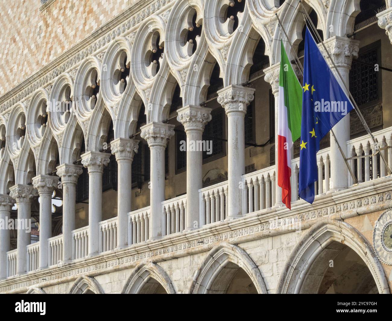 Bandiere italiane ed europee sono appese dalla loggia del Palazzo Ducale sopra la galleria al piano terra, Venezia, Veneto, Italia, Europa Foto Stock