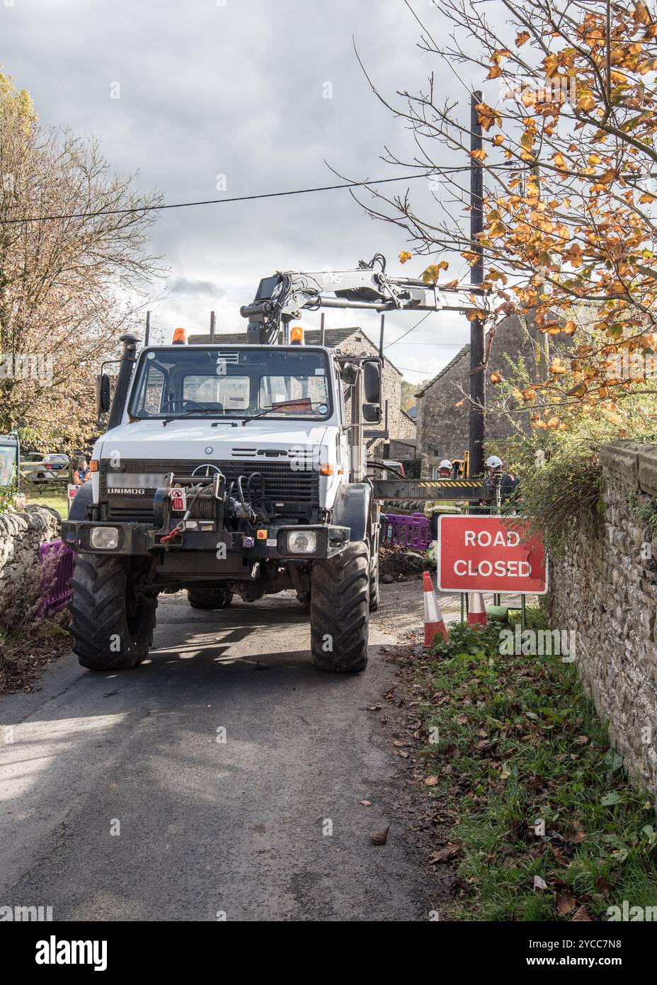 Unimog per tutti i terreni, un robusto veicolo commerciale con tecnologia moderna e applicazioni versatili utilizzato qui per la sostituzione dell'asta del telegrafo. Foto Stock