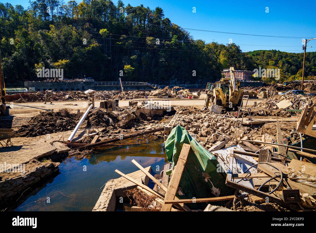 Jacob Chipman, assegnato alla 882nd Engineer Company, North Carolina National Guard, esce da un High Mobility Engineer Excavator mentre ripulisce i detriti da un canale di drenaggio critico a Marshall, North Carolina, 18 ottobre 2024. La Joint Task Force North Carolina lavora 24 ore al giorno, in una dozzina di contee, per ottenere l'aiuto di cui hanno bisogno. (Foto dell'esercito degli Stati Uniti di staff Sgt. Joe Roudabush) Foto Stock
