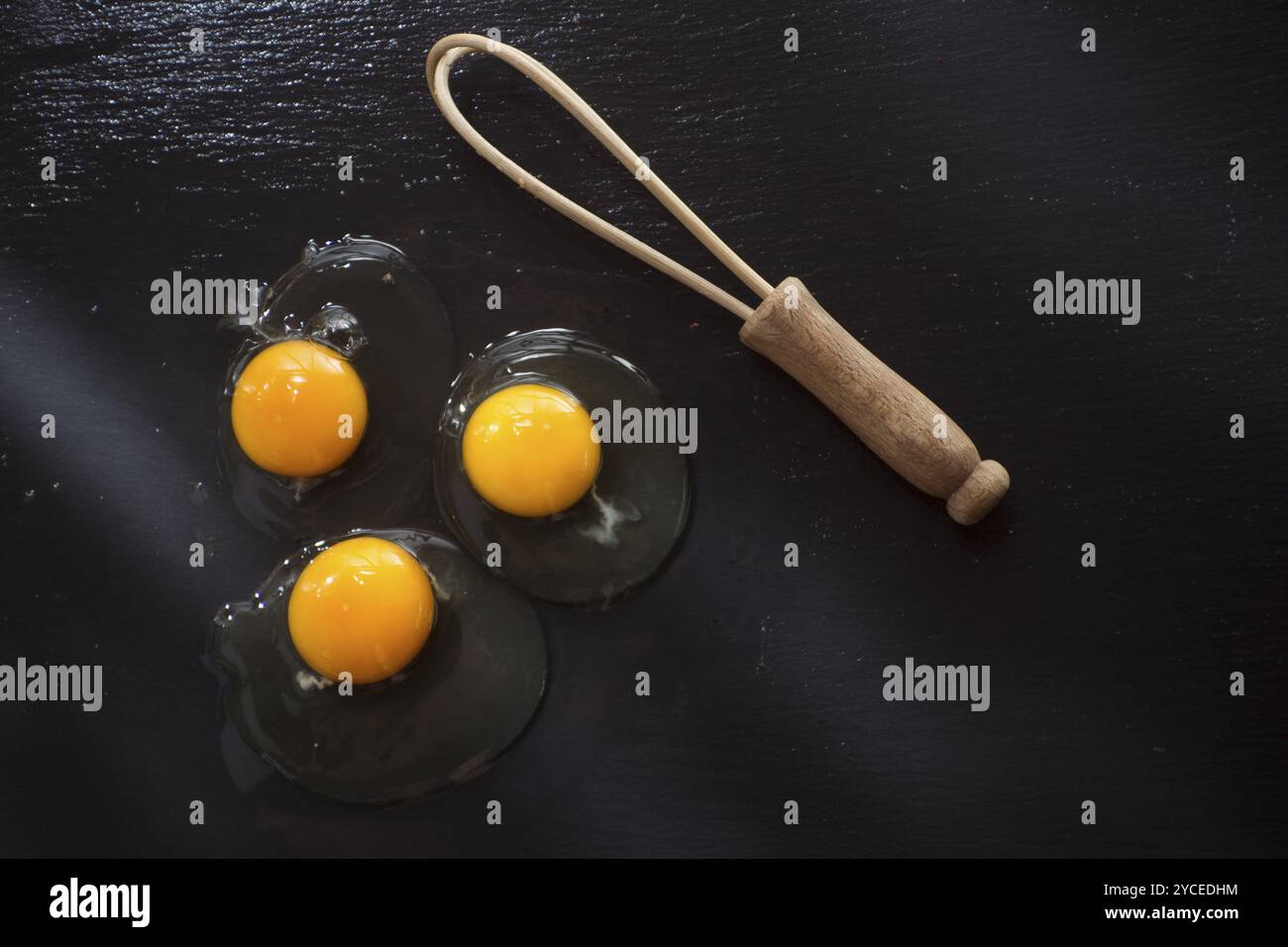 Presentazione di fresco e uova crude sul pavimento nero di pomice Foto Stock