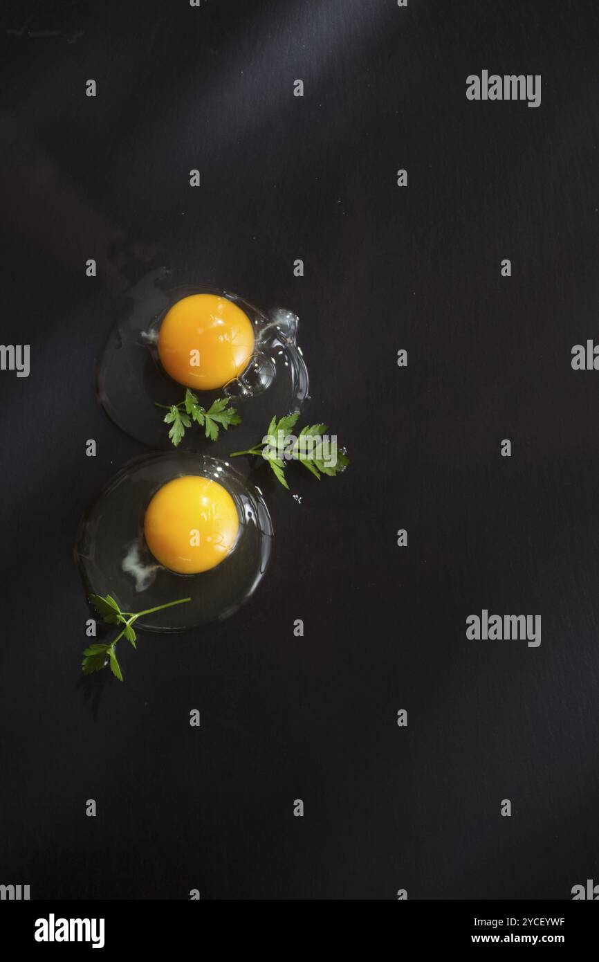 Presentazione di fresco e uova crude sul pavimento nero di pomice Foto Stock